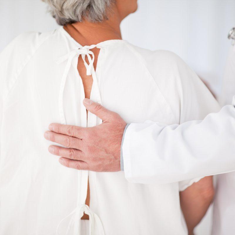 Doctor helping his patient to walk